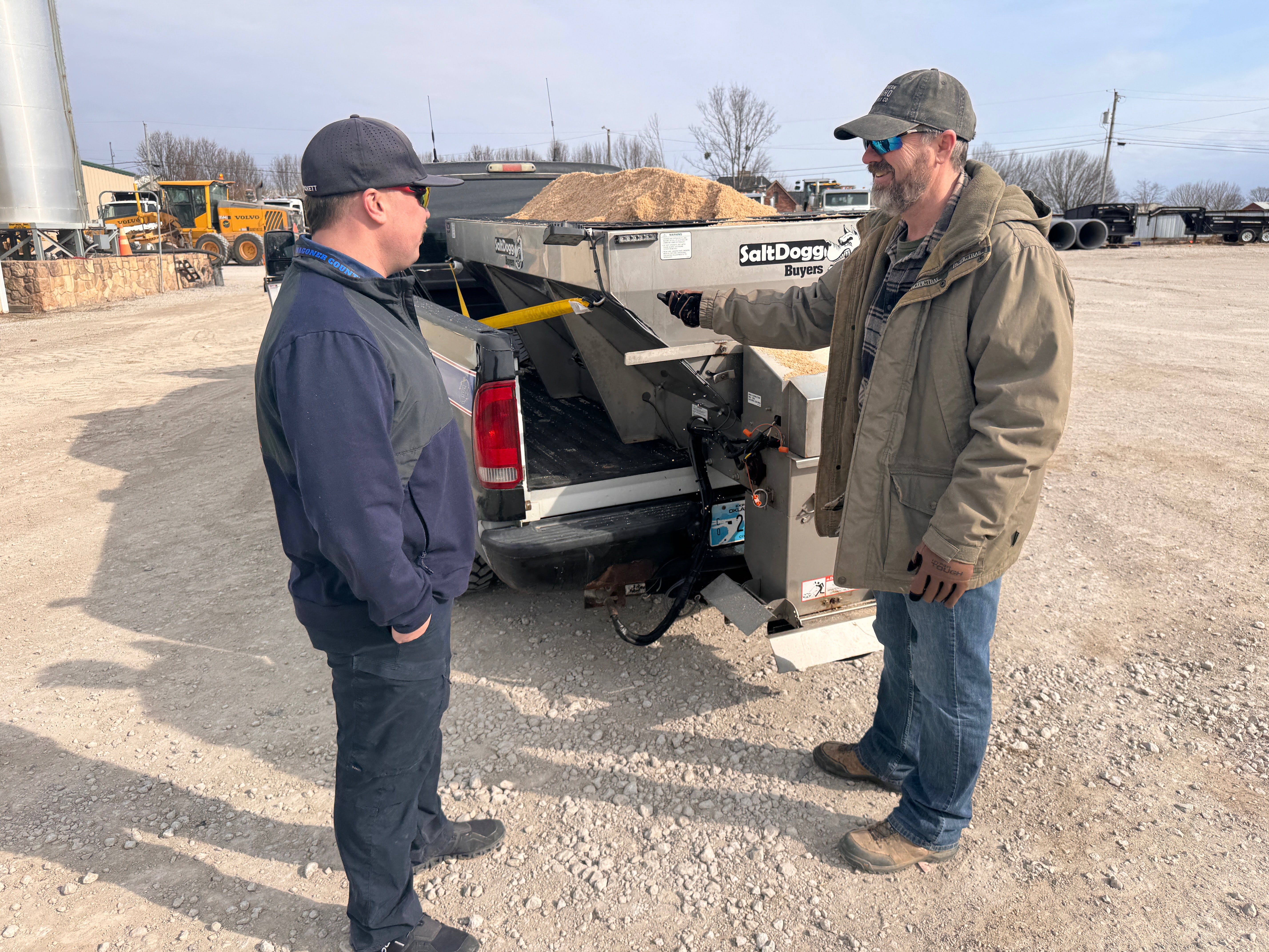 Commissioner Hanning at a Wagoner County operations yard reviewing equipment with a county worker