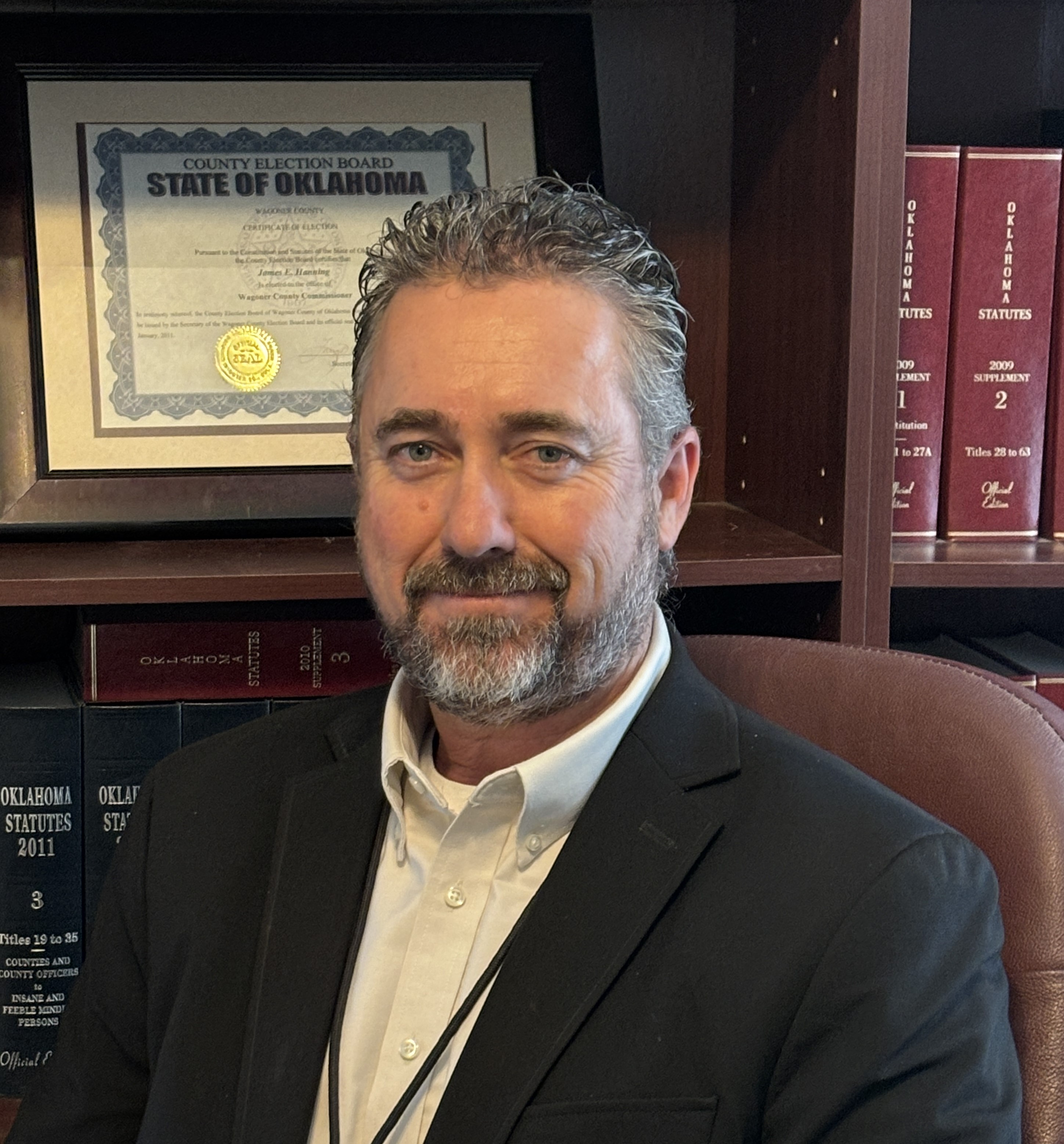 Commissioner James Hanning, with his certified Oklahoma County Election Board Certificate of Election framed behind him