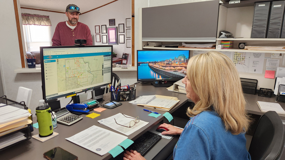 Commissioner James Hanning at his office reviewing District 1 records and maps